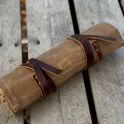 Waxed canvas knife and tool roll with leather straps, perfect for storing tools and knives up to 11 inches long.