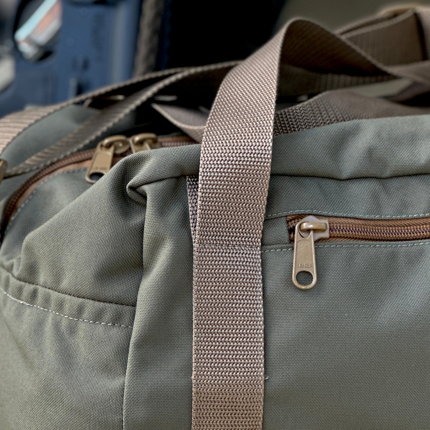 Close-up of Recon 30L duffel bag featuring durable fabric and zippers, ideal for travel and outdoor adventures.